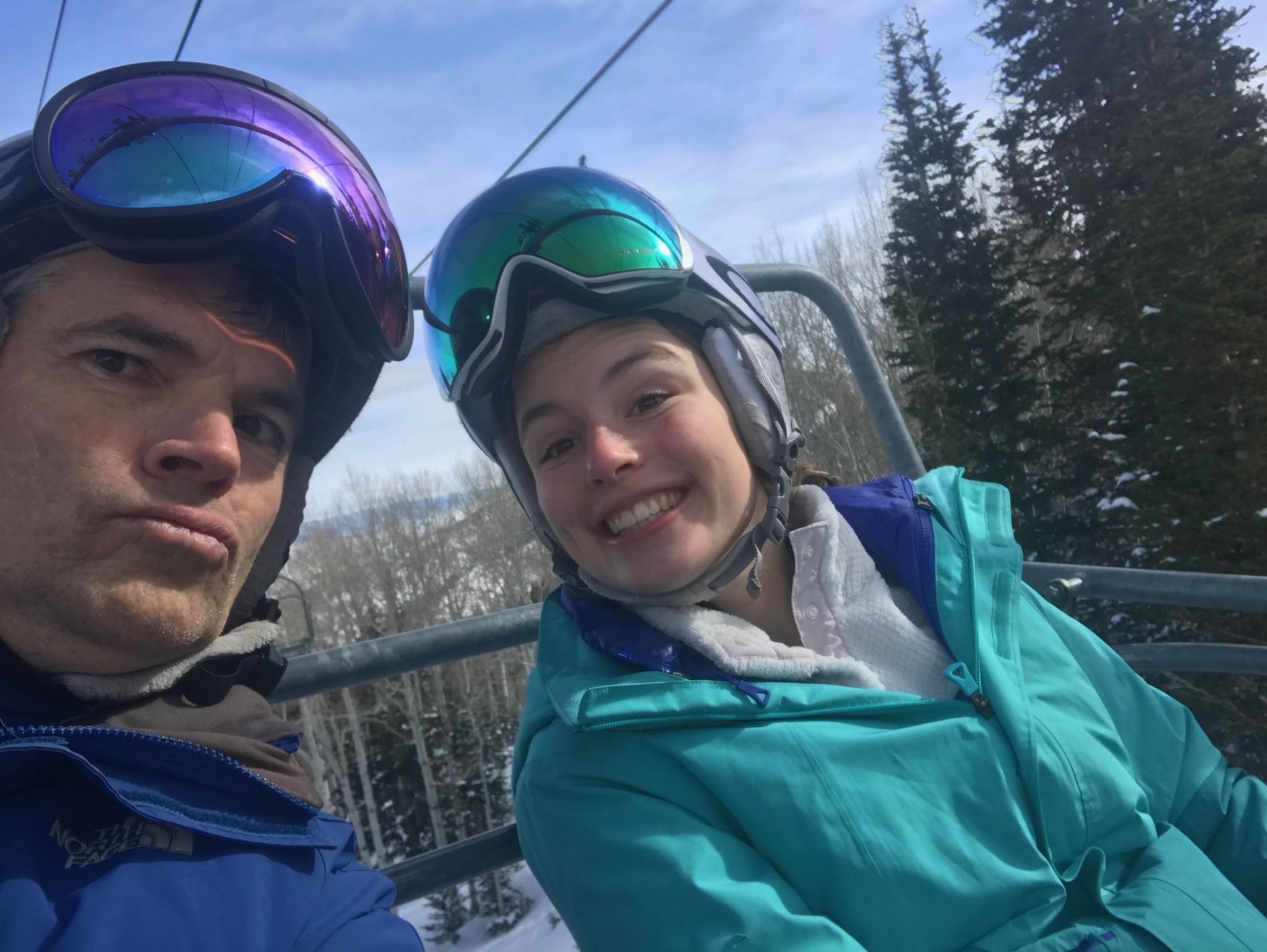 Alex Peters sitting with friend on a ski lift