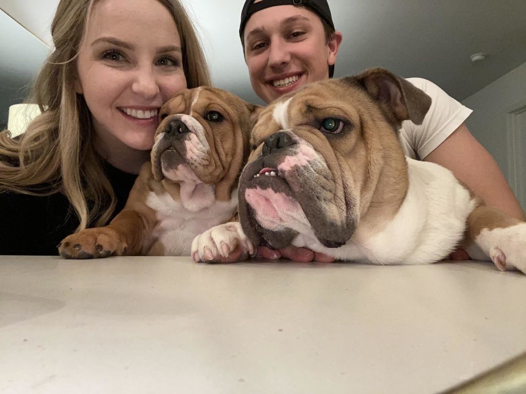Jack and his wife pose with their two english bull dogs.